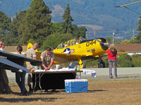 N7522U @ KWVI - 2010 Watsonville Fly-In: USAF Reserve C-17A crew setting up table ewith Harvard Mark IV N7522U in background - by Steve Nation