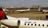 N815AE @ KDCA - N571RP in the forground, N815AE in the distance.  Note the US Captol in the far distance. - by Ronald Barker