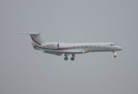 N674RW @ MIA - Coca Cola G550 landing in the rain, in town for NASCAR Homestead race - by Florida Metal