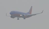 N649SW @ ONT - On final for 26R half mile out and coming out of the low clouds - by Helicopterfriend