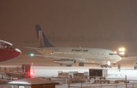 C-FNVK @ CYXY - Getting ready to load Arctic Winter Games teams on a snowy night in Whitehorse. - by Murray Lundberg