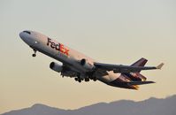 N596FE @ KLAX - Departing LAX at first light - by Todd Royer