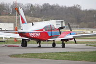 N5038Y @ KIOW - Photo shot through a chain-link fence.  The aircraft was pulled out of the hangar for some engine work, and was shortly thereafter pushed back in. - by Glenn E. Chatfield