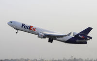N621FE @ KLAX - Departing LAX on 25R - by Todd Royer
