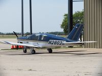 N2802W @ SLN - Parked next to a hanger - by Helicopterfriend