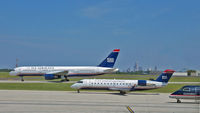 N439AW @ CLT - A U S Airways Boeing B757, a U S Airways Express Bombardier CL-600-2B19 and a U S Airways Express Dash-8 taxiing at Charlotte/Douglass International Airport. - by mcmtanyel