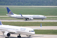 N37273 @ KIAH - UAL B738 lands 8R behind company B752 taxiing to the gate. - by Darryl Roach