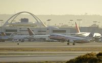 N956AN @ KLAX - Departing LAX on 25R in the first rays of sunlight - by Todd Royer