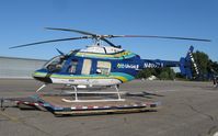 N407LL @ KAXN - LifeLink III Bell 407 on the pad. - by Kreg Anderson