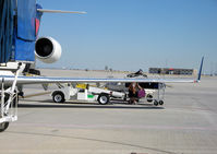 N487CA @ KSLC - Unloading baggage SLC, UT - by Ronald Barker