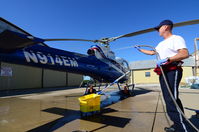 N914EM @ CNU - Pilot Jeff Meyer washes N914EM during a brilliant fall day at the Chanute Municipal Airport. - by Tim Erickson