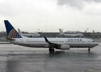 N73276 @ KEWR - A United 737, originally built for Continental in 2002, braves a downpour at Newark Liberty International Aiport. - by Daniel L. Berek