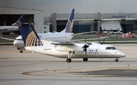 N363PH @ KEWR - A United Express Dash-8 sashays past a United Boeing 737-924 at Newark International. - by Daniel L. Berek
