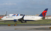 N187DN @ KEWR - A Delta 733 taxies out from Newark to a European destination. - by Daniel L. Berek