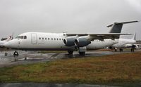 G-CCTB @ EGHH - Waiting in the drizzle for its turn in the paintshop. - by John Coates