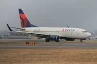 N310DE @ KBDL - Delta 737-700 flight 1049 taxiing onto Echo, soon to join Charlie, then onto runway 24 to Hartsfield-Jackson Intl. - by Mark K.