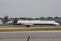 N928LR @ KSRQ - US Air Flight 2678 operated by Mesa (N928LR) taxis at Sarasota-Bradenton International Airport - by Jim Donten