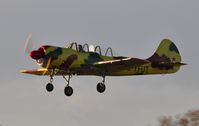 G-YFUT @ EGFH - Morning departure. Visiting Yak-52 returning to base. - by Roger Winser