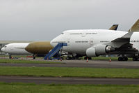 N90GZ @ EGHH - Ex A9C-GZ, registered on 18th August 2009, with 747 9V-SPG in the foreground. - by Howard J Curtis