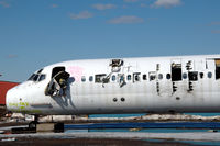 SE-RDR @ ESSP - MD-82 in derelict state at Norrköping Kungsängen airport, Sweden. It is being used as a source for spares and to be scrapped. Note the graffiti on its nose. - by Henk van Capelle