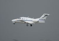N414TW @ ORL - Eclipse 500 taking off into thunderstorm