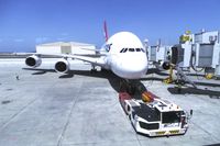 VH-OQI @ KLAX - Qantas David Warren A380-842 taken from inside the new Tom Bradley International Terminal on LAX Appreciation Day at Gate 150 with tug at the ready.  Take note of the 3 jet bridges. - by speedbrds