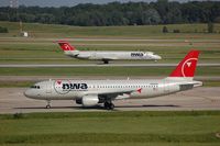 N364NW @ KDTW - NWA A320 passing a DC9 - by FerryPNL