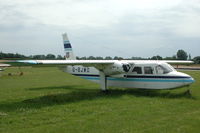 G-BJWO @ EGBT - Islander minus engines parked on the grass of Turweston airfield. - by Henk van Capelle