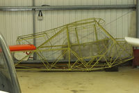 G-BCOM @ EGKA - fuselage of Piper J3C-65 Cub stored in a hangar at Shorham - by Chris Hall