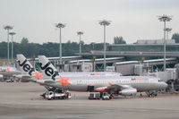 9V-JSE @ WSSS - Jetstar A320s parked at Singapore's Changi airport. - by Henk van Capelle