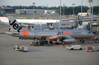 VH-VGI @ WSSS - JetStar Airways A320-200 parked at the terminal of Singapore Changi airport. - by Henk van Capelle