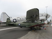 N91163 @ CMA - 1946 North American NAVION, Continental E-225, finished/stenciled as a UC-17 warbird, but never was a UC-17, on CAF ramp under wing of their C46 'China Doll' - by Doug Robertson