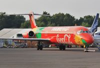 OY-RUE @ EGHH - Awaiting delivery after repaint into special Coca Cola / FIFA World Cup scheme. - by John Coates