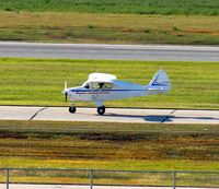 N7138B @ KGFK - Piper PA-22-150 Tri-Pacer taxiing to the FBO. - by Kreg Anderson