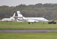 G-LSMB @ EGHH - Being towed past M-CICO - by John Coates