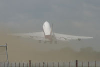 VP-BAT @ EGHH - A series of three. This is what happens when a 747SP departs and you've just mown the grass. Photo 3/3: green fog and a lot of sweeping up needed! - by Howard J Curtis