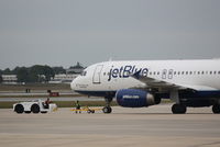 N648JB @ KSRQ - JetBlue Flight 164 (N648JB) That's What I Like About Blue prepares for flight at Sarasota-Bradenton International Airport - by Donten Photography