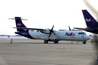 N802FX @ KCID - At the FedEx ramp, photographed through a chain-link fence