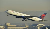 N128DL @ KLAX - Departing LAX on 25R - by Todd Royer