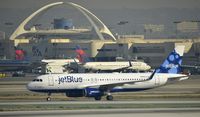 N834JB @ KLAX - Taxiing to gate at LAX - by Todd Royer
