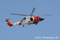 6021 @ KSRQ - USCG HH-60 Jayhawk (6021) from Air Station Clearwater flies over Sarasota-Bradenton International Airport - by Donten Photography