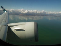 ZK-NCJ @ NZAA - The clouds mirror in the water of Manuaku Harbour as we climb out of AKL enroute to HNL - by Micha Lueck