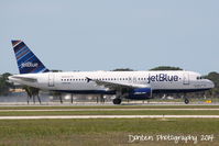 N648JB @ KSRQ - JetBlue Flight 164 (N648JB) That's What I Like About Blue departs Sarasota-Bradenton International Airport - by Donten Photography