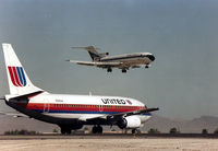 N330UA @ KLAS - KLAS - Delta 727 arriving over the numbers as UAL 737 N330UA waits its turn for departure. - by Tom Vance