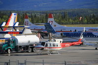 N73HJ @ CYXY - Fueling up on the very busy ramp at Whitehorse, Yukon, with water bombers headed to Alaska to help fight the Funny River fire. - by Murray Lundberg