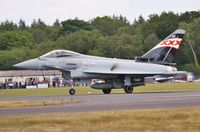 ZK343 @ EGHH - Off to display at Goodwood passed a packed cafe - by John Coates