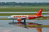 G-EZIO @ EDDL - Easy Jet (Unicef cs.), see the reflections on the wet taxiway - by A. Gendorf