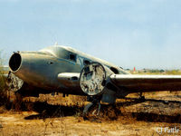 N495F @ LMML - Scanned from print. Remains of Beech 18/C-54H N495F at the International Fire Training Centre at Hal Far (disused) Malta. ICAO LMML used for ref/search purposes. A/c is ex  USAF 52-10958 - by Clive Pattle