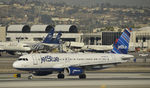 N597JB @ KLAX - Landing on 25L at LAX - by Todd Royer