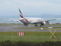 A6-EFO @ NZAA - departing on wet runway - by magnaman